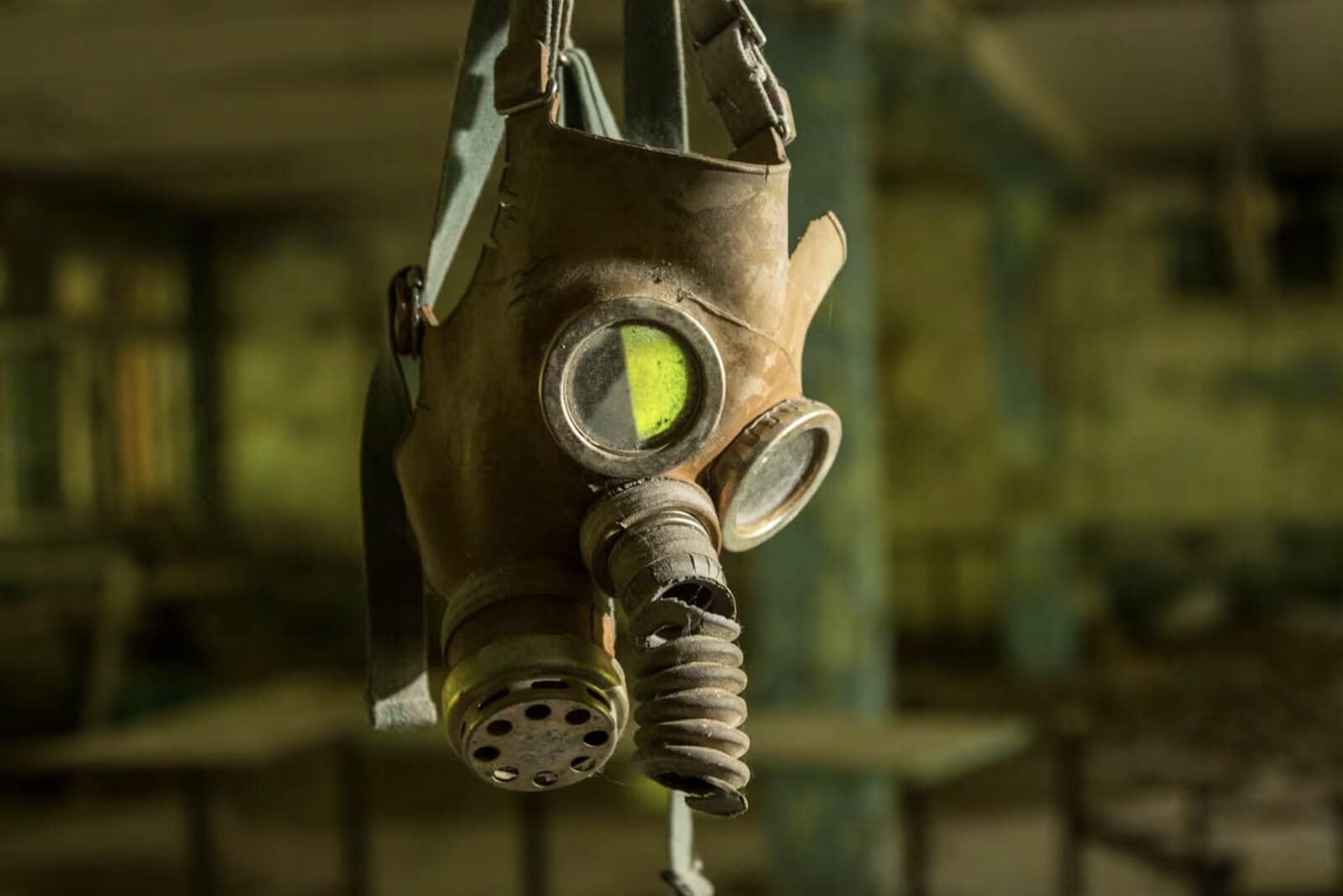 A gas mask hanging by its strap