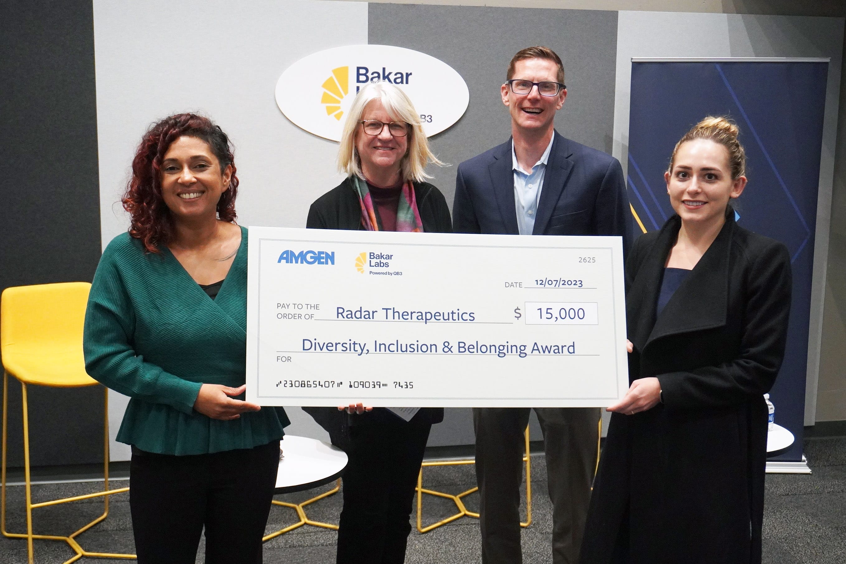 Radar Therapeutics co-founder & CEO Sophia Lugo (right) accepts the award from, L-R, Amgen's director of technology and strategic alliances and therapeutic discovery; Kelly Huggins; chief of staff Laura Parmer-Lohan; and executive director Jason DeVoss.